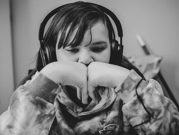 Close-up of girl listening music at home