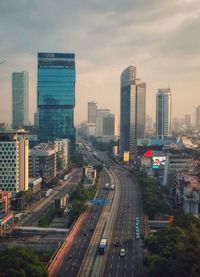 High angle view of street amidst buildings in city against sky