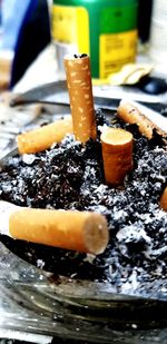 Close-up of cigarette smoking on table