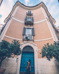 Woman standing at entrance of building