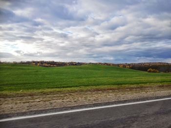 Scenic view of landscape against cloudy sky