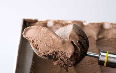 Close-up of chocolate cake on table against white background