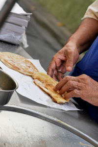 Midsection of man preparing food on table