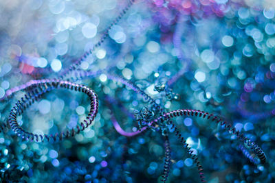 Abstract background of blue-purple metal shavings with bokeh.