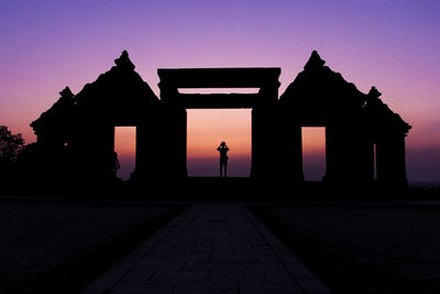 Built structure against sky at sunset