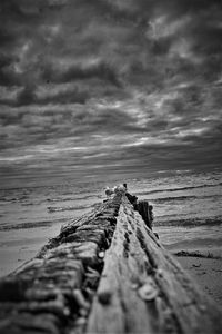 Pier on beach against sky