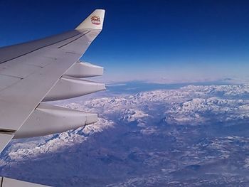 Cropped image of airplane flying over landscape