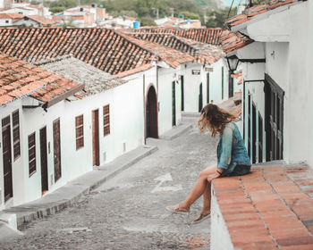 Rear view of woman walking on footpath