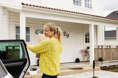 Woman in front of house