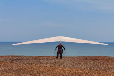 Rear view of woman walking at beach