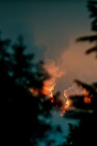 Close-up of illuminated lights against sky at night