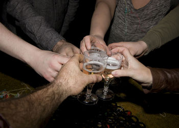 Cropped image of friends toasting drink