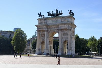 People walking in front of historical building