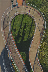 Russia, aerial view of woman walking along winding boardwalk