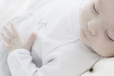 Close-up of baby sleeping on bed