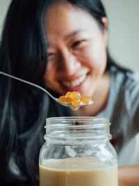 Close-up portrait of woman holding ice cream