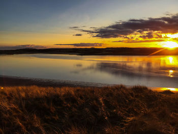 Scenic view of lake at sunset