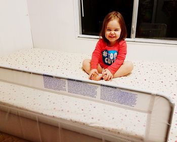 Portrait of smiling girl sitting at home