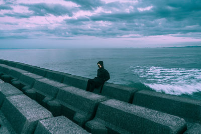 Man looking at sea against sky