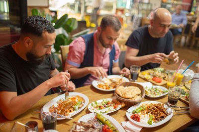 Group of people having meal in restaurant