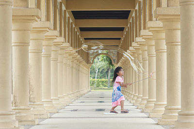 Rear view of woman walking on staircase in building