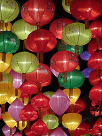 Low angle view of illuminated lanterns hanging in the street. 