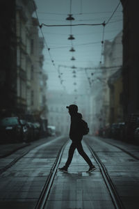 Full length of man walking on railroad tracks