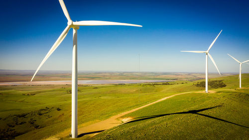 Windmill on field against sky