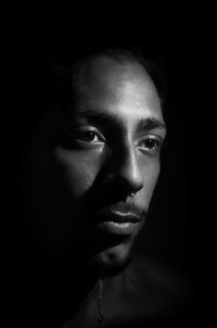 Close-up portrait of young man in darkroom