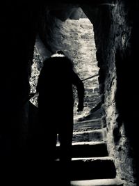 Silhouette woman standing in tunnel