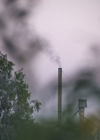 Smoke emitting from chimney against sky