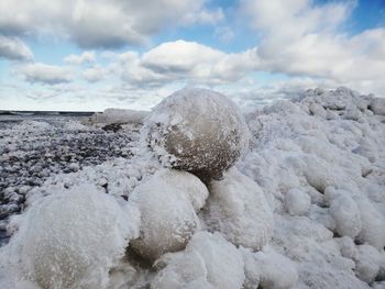 Rocks in sea against sky during winter