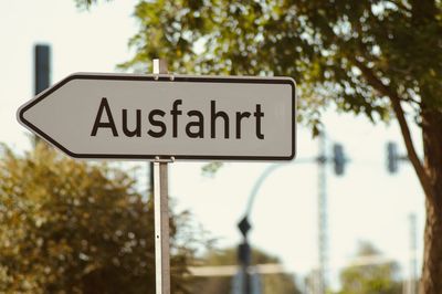 Low angle view of road sign against trees