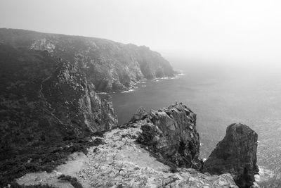 Scenic view of sea and mountains against sky