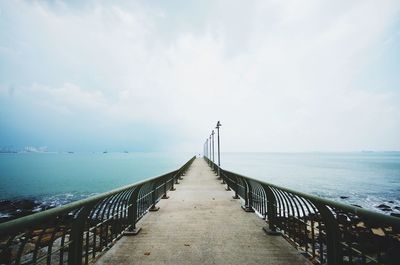 Pier over sea against sky