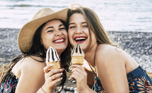 Portrait of happy female friends holding ice cream cones