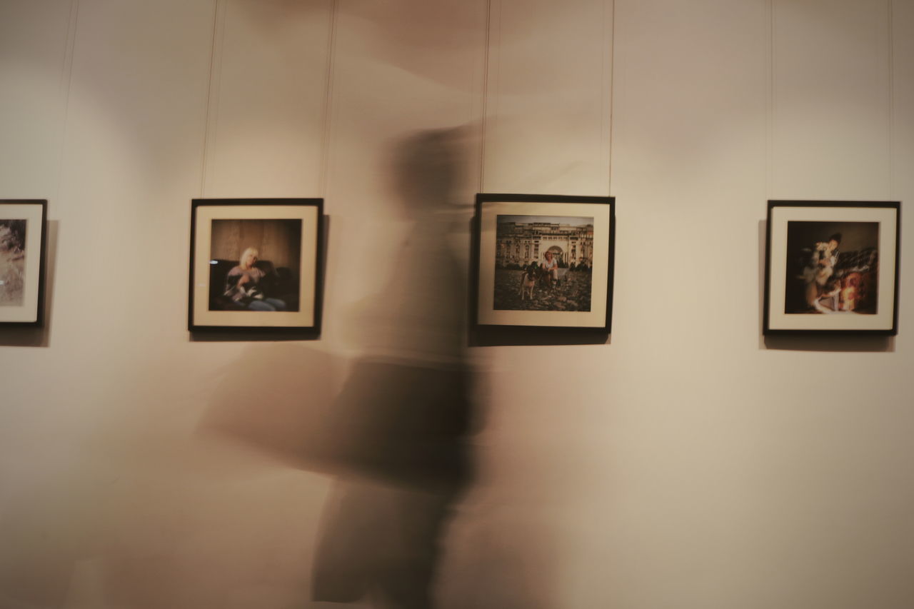 MIDSECTION OF WOMAN STANDING IN FRONT OF MUSEUM