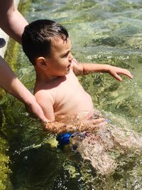 Full length of shirtless boy in water