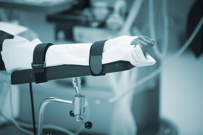 Cropped hand of patient with medical equipment at hospital