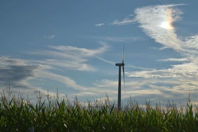 Scenic view of field against cloudy sky