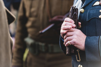 Close-up of man holding leather gloves