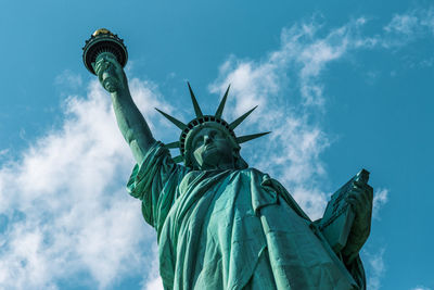 Low angle view of statue of liberty against sky