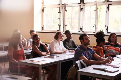 Multi-ethnic students learning language in classroom