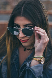 Portrait of young woman wearing sunglasses