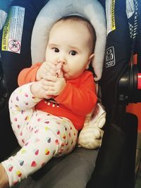 Close-up of cute baby boy sitting in airplane