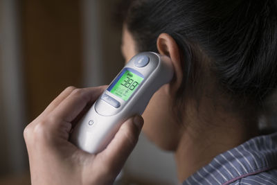 Woman checking her temperature