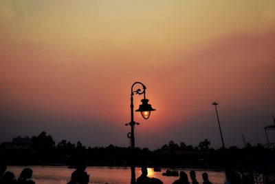 Silhouette street light against sky during sunset