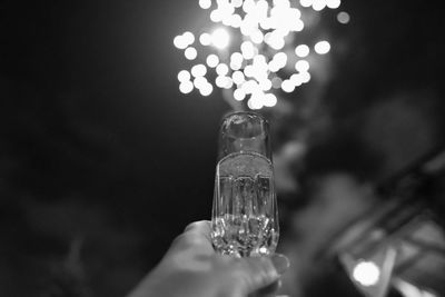 Cropped hand of woman drinking glass