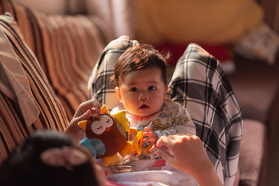 Mother playing with cute baby at home