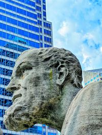 Low angle view of statue against sky in city